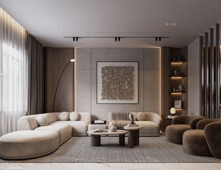 Warm greige living room with curved cream sofas, brown accent chairs and textured wall art